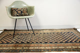 Vintage Kurdish Bijar rug detail with repeating Mir motif and unique pawn design border.