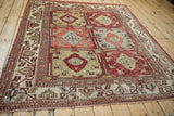 Full corner view of a vintage Oushak carpet, displaying its paneled design in red, saffron, and silver.