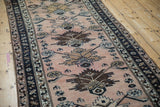 Dusty blush abrashed ground of a Hamadan runner with chocolate floral palmettes and navy border.