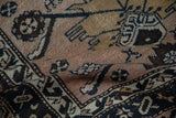 Detail view of a Hamadan rug showing partial Herati pattern in dusty mauve, navy, and ivory, with even pile wear.