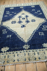 Corner view of a distressed Oushak rug showing the stepped spandrel in cobalt blue and cream.