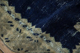 Close-up showing the distressed pile and knot heads in cobalt blue and pale gold.