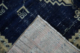 Corner view of a vintage Turkish rug showing its hand-knotted foundation and machine-bound edge.