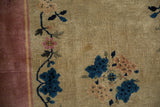 Nichols Art Deco rug detail: mauve border, ivory field, cobalt blue lotus blossoms.