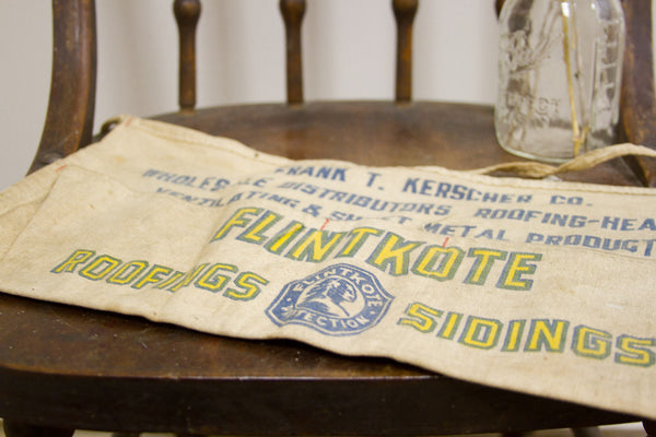 Yellow and blue Flintkote logo and text on the vintage canvas roofer's apron.