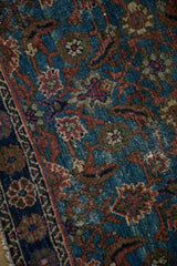 Textured Herati pattern on distressed Hamadan rug, with rich sapphire and warm terracotta hues.