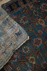 Distressed Hamadan rug pile with Herati pattern and visible woven foundation.