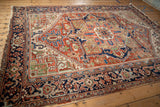 Heriz carpet's brick red field, navy border, unusual jade green elements, and excellent light blue abrashes.