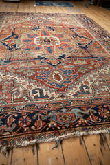 Tattered fringe with foundation showing, and patterned Samovar border on vintage Heriz rug.