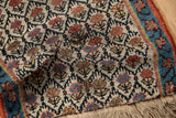 Antique Kurdish rug mat's textured hand-knotted pile, trellis pattern, and distinct faux fringe.