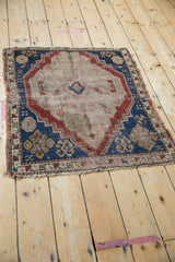 Antique Caucasian rug detail: indigo, cherry borders, primitive motifs, foundation showing through.