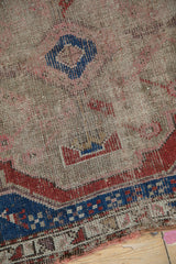 Wear revealing foundation and primitive geometric patterns on this antique Caucasian rug.