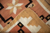 Folded vintage Southwestern Navajo rug, highlighting soft wool texture and secured selvage.