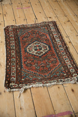 Geometric Herati-style pattern, brick red and dusty blue, on a vintage Hamadan rug.