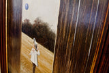 Dark wood frame edge of the Thomas Kerry painting with white streaking.