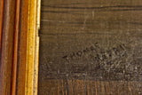 Thomas Kerry's signature on vintage painting, with aged wooden frame detail.