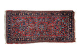 Vintage Lilihan rug with a central floral medallion in raspberry red, navy blue, and sky blue.