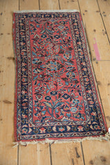 Vintage Persian Lilihan rug seen from a high angle, displaying a full floral design in raspberry red and navy blue.