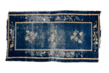 Hand-knotted Antique Peking rug, cobalt blue field, faded floral sprays, worn patina. 2'1