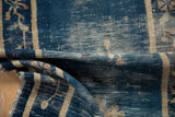 Antique Peking rug's rolled side reveals foundation wear, cobalt blue, and beige minor border.