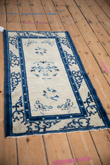Antique Chinese Peking runner's ivory field with blue blossoms and curvilinear border.