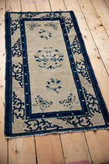 Detail of antique Peking rug medallion with ivory field and cobalt, sky blue floral motifs.