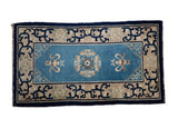Antique Peking rug with central roundel, cloud band vases, arabesque border, blue and beige. 2'4