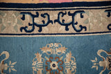Antique Peking rug border showing blue arabesques, nuanced contours, and varied pile.