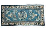Antique Chinese Peking runner with sky blue field, floral bat medallion, and Running T border. 2'11