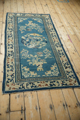 Corner of an antique Chinese Peking runner, displaying germinating plants and the Running T border.