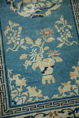 Antique Peking runner detail: worn sky blue field, ivory plants, and Running T border.