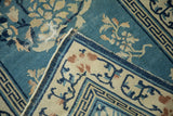 Antique Peking runner detail: wear to knot heads revealing foundation, tattered edge, geometric border.