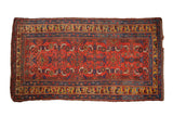 Antique Kurdish Bijar rug with a geometric Herati design in gem-like ruby red, sapphire blue, and saffron.