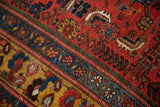 Close-up on the geometric contour and dense wool pile of an antique Kurdish Bijar rug.