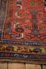 Antique Kurdish Bijar rug corner showing detailed geometric motifs, gem-toned colors, and low pile texture.