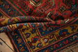 Folded antique Kurdish Bijar rug displaying its dense, textured pile and rich gem-like colors.