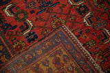 Folded corner of an antique Kurdish Bijar showing its dense wool pile and handwoven foundation.