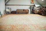 Vintage oversize Oushak carpet with antique ivory and softened orange sprawling design, 10'10