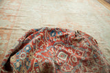 Sultanabad fragment with vibrant red and blue folded pattern revealing light ivory field.