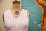 Vintage 70s white knit cropped top, detailed geometric pattern and V-neck.