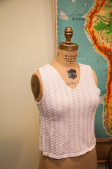 Vintage 70s white knit cropped top showcasing its textured chevron pattern and V-neck.