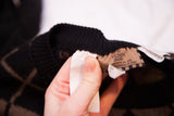 Vintage Fendi sweater brand label with logo and text on the black ribbed collar.