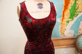 Textured burgundy velvet dress bodice with scattered dark cat pattern.