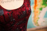 Textured burgundy velvet dress with playful black cat pattern.