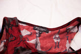 Betsey Johnson brand tag on vintage burgundy velvet dress, highlighting cat pattern.