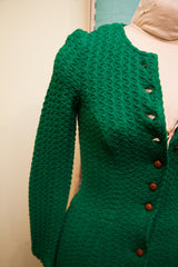 Vintage green dress bodice, distinctive textured pattern, and brown wooden buttons.