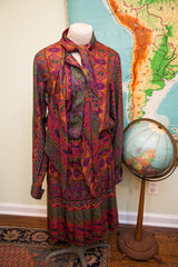 Pleated hem of the 70s Oscar de la Renta dress, with a vibrant red and purple psychedelic pattern.