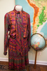 Pleated skirt with vibrant 70s psychedelic pattern on the Oscar de la Renta dress.