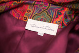 Oscar de la Renta label on rich burgundy lining with vibrant psychedelic paisley.