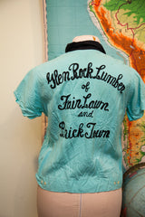 Back of vintage light turquoise 50s bowling shirt with black embroidered 'Glen Rock Lumber' text.